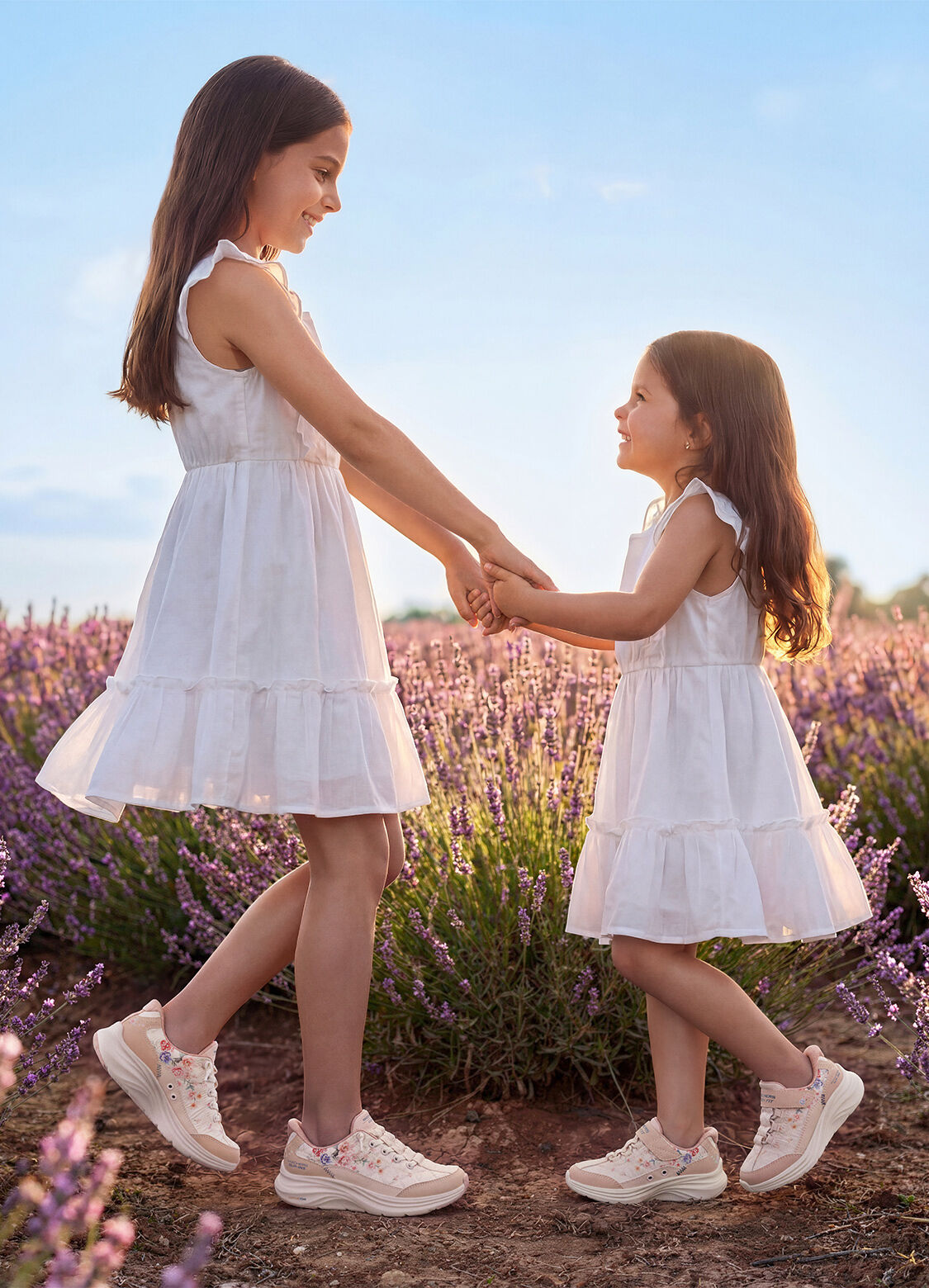 girls holding hands in Skechers
